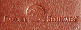 organizational logo debossed on a tan journal cover